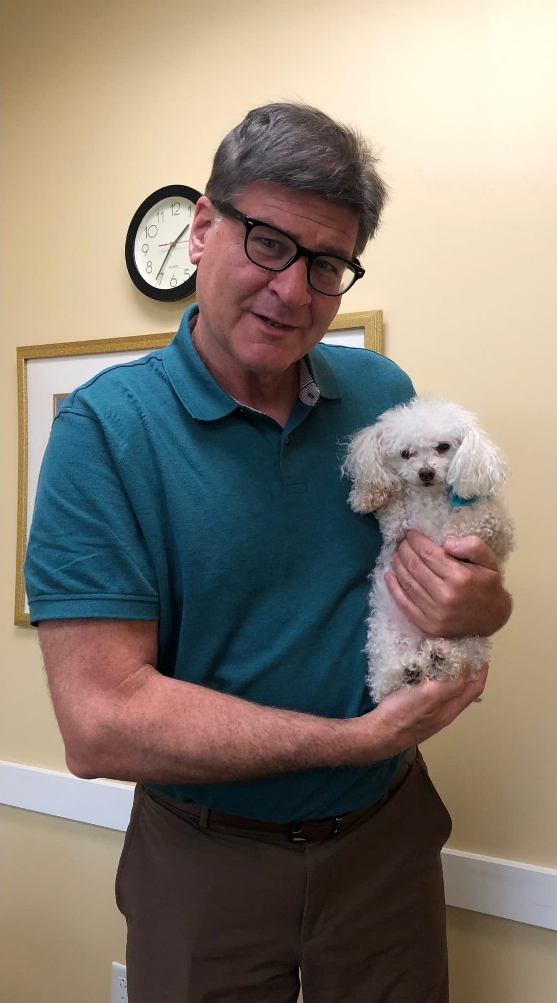 Occupational therapist Desmond Pegley holding Ruby, a therapy dog